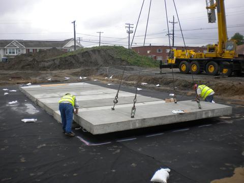 Concrete lid with lifting lugs for stormwater detention vault.